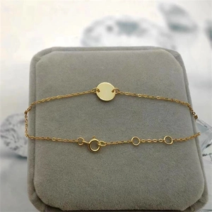 Minimalist gold S925 silver bracelet with polished circular disc on velvet display box