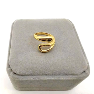 Irregular hollow water drop silver ring in gold finish displayed in a gray velvet jewelry box