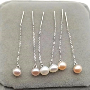Macro detail of S925 sterling silver ear wires with white, pink and orange pearls