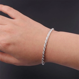 Detailed view of S925 sterling silver twisted rope chain bracelet on a wrist