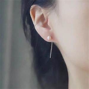 Close-up of elegant S925 silver thread earrings with pink freshwater pearls and tassels