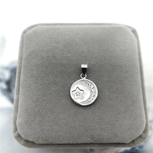 Macro detail of S925 sterling silver moon and star pendant with cubic zirconia inlay