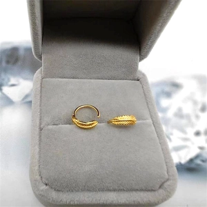 Detailed close-up of S925 sterling silver golden leaf feather earrings in a velvet gift box