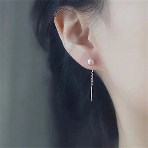 Close-up of elegant S925 silver long drop tassel earrings with natural freshwater pearls
