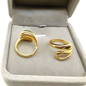 Polished golden S925 sterling silver irregular wavy open rings on grey velvet display