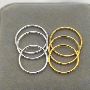 Polished S925 silver and gold minimalist thin bands on a gray velvet jewelry box
