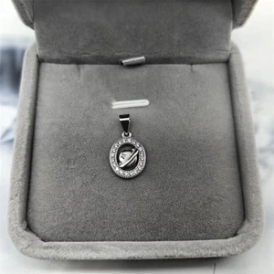 Macro view of S925 sterling silver planet pendant with sparkling cubic zirconia pavé