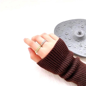 Close-up of gold and silver S925 rings with irregular hammered texture on hand