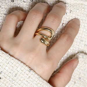 Macro shot of gold-plated triple-layer hollow waterdrop ring on model finger