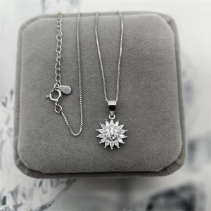 Detailed close-up of S925 silver sunflower pendant necklace with sparkling cubic zirconia