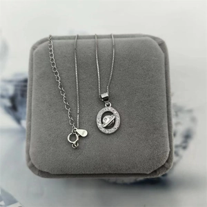 Close-up of S925 sterling silver planet pendant necklace with sparkling zircon pavé