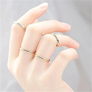 Close-up of minimalist gold and silver stacked bands on fingers in S925 sterling silver