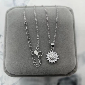 Macro shot of S925 hallmark on silver sunflower pendant with marquise zircons