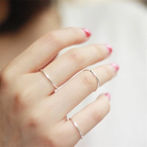 Detailed close-up of a three-piece set of minimalist polished S925 silver stackable rings