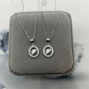 Detailed close-up of S925 silver planet pendants with pavé diamonds on a jewelry box