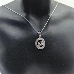 Close-up of S925 sterling silver planet necklace with sparkling cubic zirconia detail