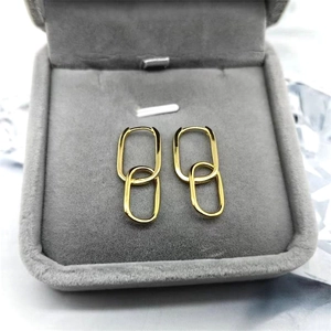 Elegant S925 silver gold-plated double oval link drop earrings displayed on a grey velvet box