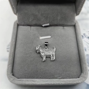Macro shot of S925 sterling silver sheep pendant with cubic zirconia in a jewelry box