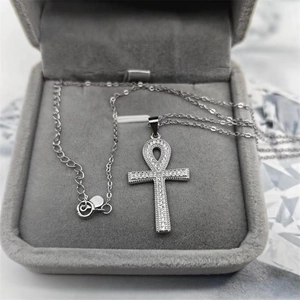 Detailed close-up of S925 silver Ankh cross pendant with pavé white zircon in a velvet box