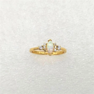 Detail shot of S925 sterling silver stamp on a gold-plated opal ring with diamonds