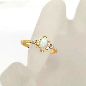 Macro shot of S925 gold-plated ring featuring marquise opal stone and side diamonds