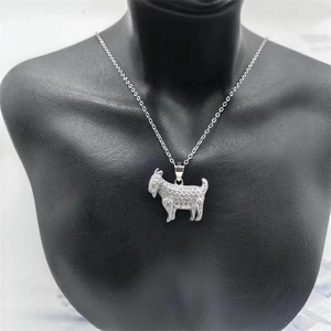 Macro view of silver S925 zodiac goat pendant with sparkling diamonds on a black bust