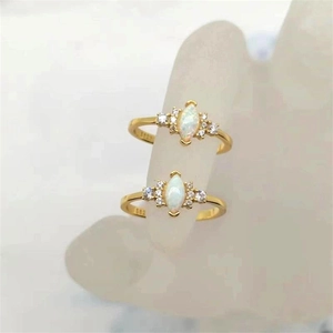 Detail of S925 sterling silver gold plated ring with marquise opal and shiny zircons