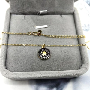 Macro detail of S925 silver starburst pendant with black stones in a velvet box