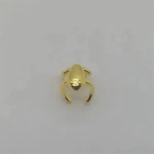 Detailed top view of a polished gold frog-shaped ear cuff with minimalist metal finish