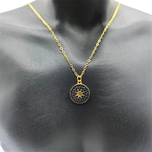 Close-up of S925 silver starburst medallion necklace with black zircon micro-pave