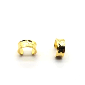 Detail shot of golden 925 sterling silver ear cuff showing irregular hammered texture