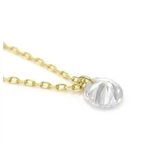 Close-up of a delicate gold chain necklace featuring a single round-cut cubic zirconia stone