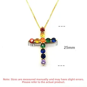 Macro detail of gold cross pendant with rainbow zircon stones, size 18.5mm by 25mm