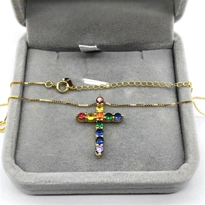 Macro detail of S925 sterling silver stamp on golden rainbow cross pendant necklace