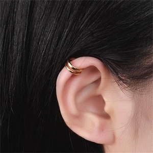 Close-up of minimalist double layer gold plated ear cuff worn on ear cartilage
