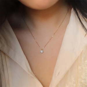 Minimalist S925 silver necklace with sparkling single zircon pendant on female model