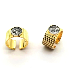 Macro detail of retro adjustable open rings with striped texture and coin relief