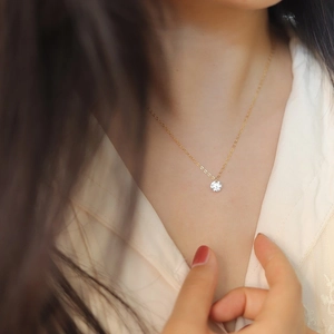 Close-up of minimalist S925 silver chain with single zircon pendant on model neck