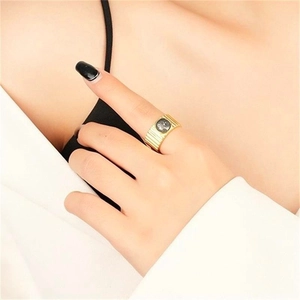 Detail of a wide gold-plated S925 silver ring featuring horizontal texture and gray stone
