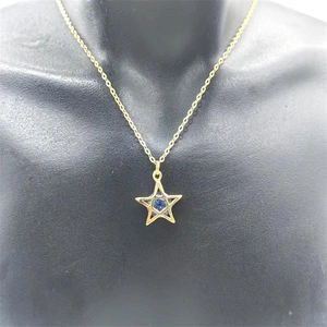 Detailed view of S925 gold-plated star pendant necklace with a blue gemstone center