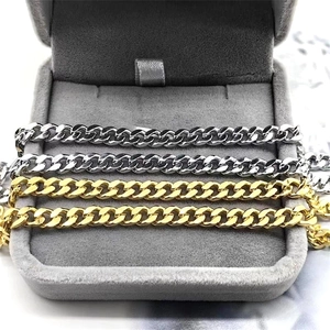 Detailed close-up of polished S925 sterling silver Cuban link chains in gold and silver
