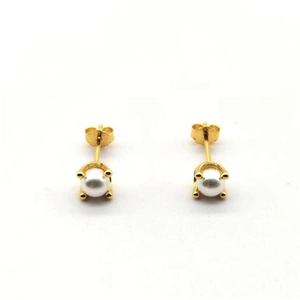 Detailed view of white pearl stud earrings with a four-claw gold-plated setting