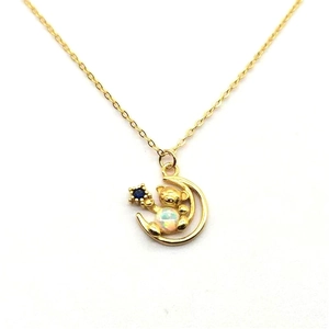 Detail of S925 gold-plated bear on crescent moon necklace with opal stone and blue star