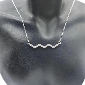 Close-up of S925 sterling silver wavy pendant necklace with sparkling micro-pave crystals