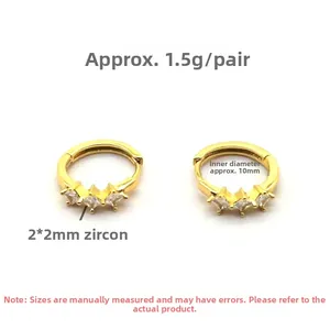 Detail of gold-plated silver huggie earrings featuring three 2x2mm square zircon stones