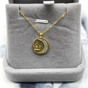 Elegant gold S925 sterling silver moon and star necklace on grey velvet display