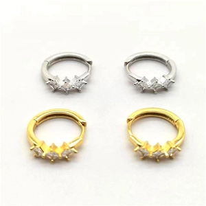 Close-up of gold and silver plated hoop earrings with three square-cut inlaid zircons