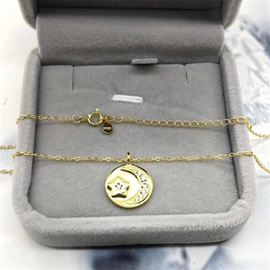 Detailed view of gold S925 sterling silver moon and star pendant with sparkling zircon