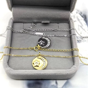 Detail of S925 sterling silver star and moon pendant necklaces in a jewelry box