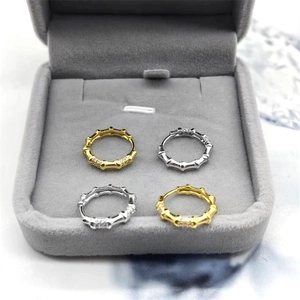 Gros plan de boucles d'oreilles créoles bambou argent et or serties de zircons brillants